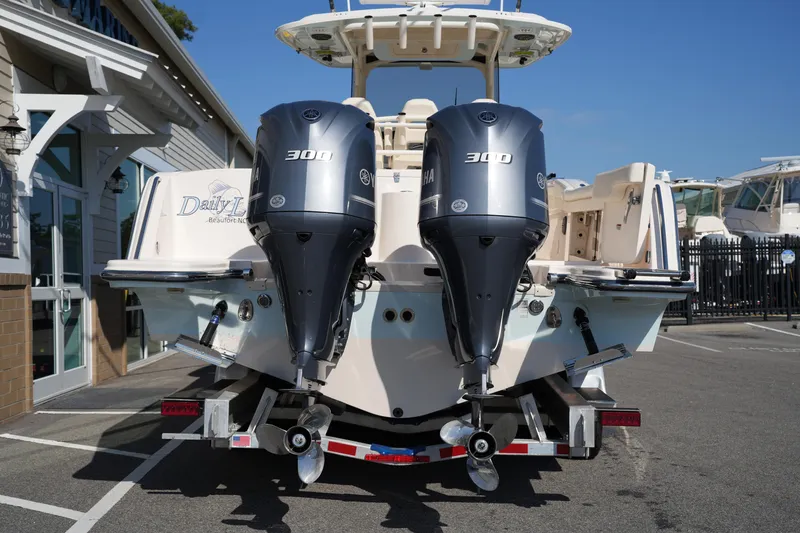 Slide: The Image of 2021 Grady-White Canyon 326 boat with dual Yamaha 300 engines, parked outdoors. - 4