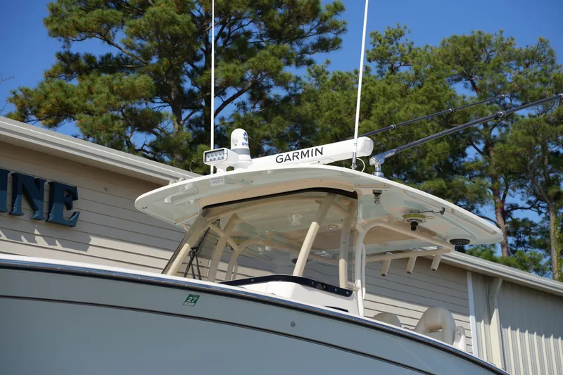 Slide: The Image of 2021 Grady-White Canyon 326 boat with Garmin equipment, docked near trees. - 40