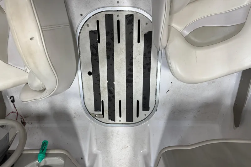 Slide: The Image of Interior of a 1999 Four Winns 170 Horizon LE boat, featuring white seating and floor details. - 10