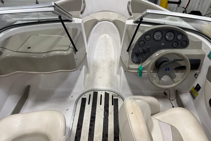 Slide: The Image of 1999 Four Winns 170 Horizon LE boat interior with steering wheel and dashboard controls. - 12