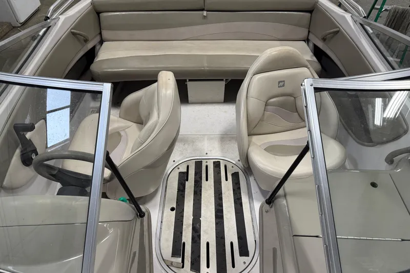 Slide: The Image of 1999 Four Winns 170 Horizon LE boat interior with beige seating and steering wheel. - 14