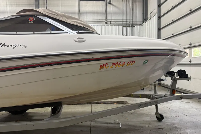 Slide: The Image of 1999 Four Winns 170 Horizon LE boat on trailer in garage. - 2