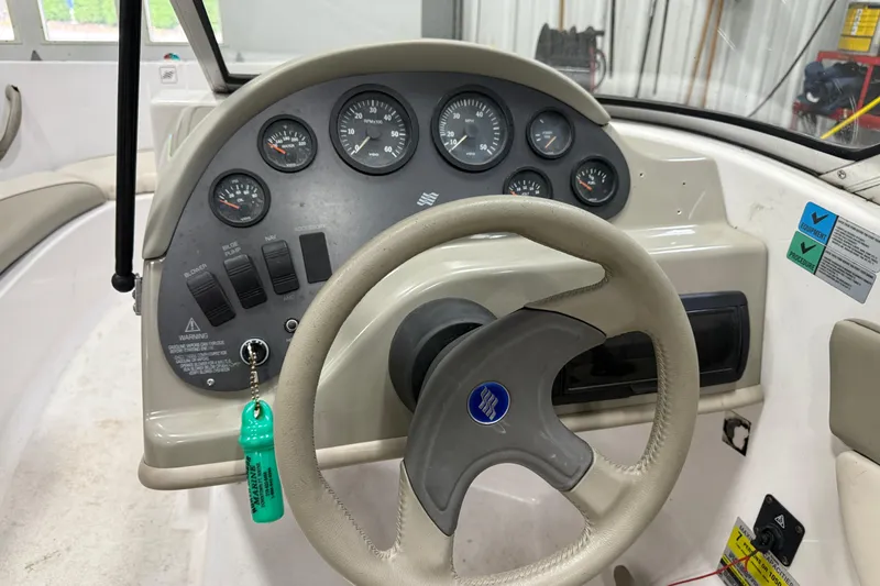 Slide: The Image of 1999 Four Winns 170 Horizon LE boat dashboard with steering wheel and instrument panel. - 9