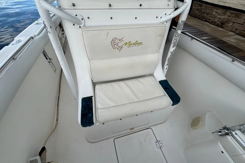 Slide: The Image of 2004 Marlago 35fs boat seat with logo, showing wear and tear. - 11