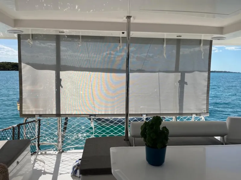 Slide: The Image of Leopard 40 catamaran interior with ocean view, featuring sunshade and seating area, 2018 model. - 10