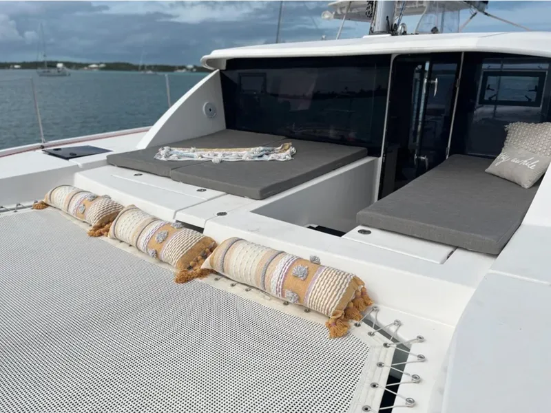 Slide: The Image of 2018 Leopard 40 catamaran with cushioned deck and netting, anchored on calm waters. - 14