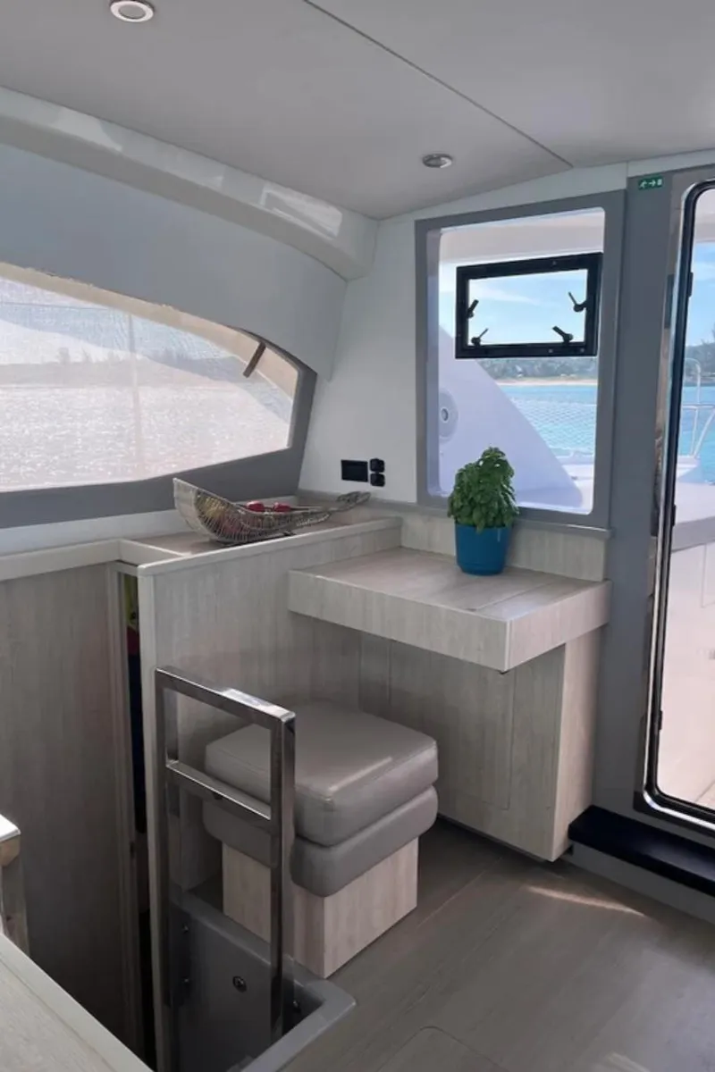 Slide: The Image of Interior of 2018 Leopard 40 catamaran with modern seating and window view. - 24