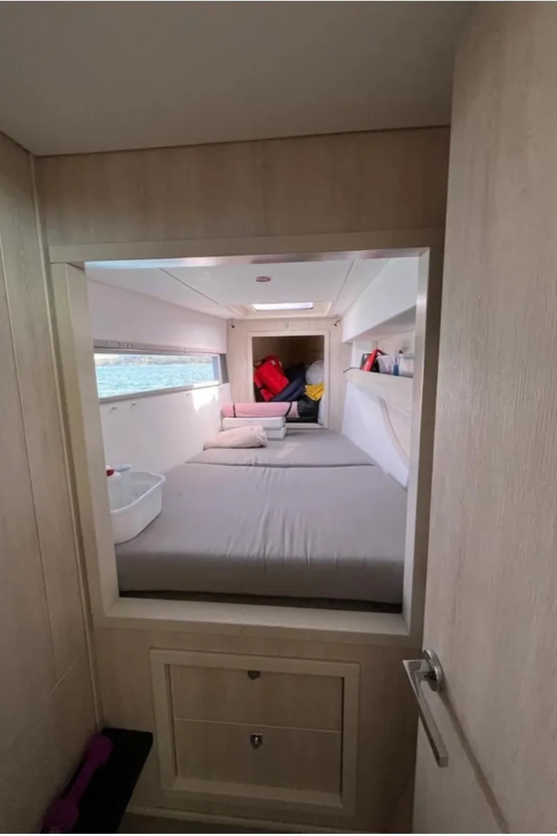 Slide: The Image of Interior cabin of a 2018 Leopard 40 catamaran with a cozy bed and storage. - 31