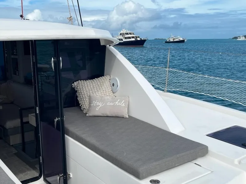 Slide: The Image of Leopard 40 catamaran, 2018 model, with cushioned seating, on a serene ocean backdrop. - 5