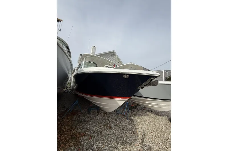 The Image of 2026 Pursuit DC 266 Dual Console boat on dry dock, front view. - 0