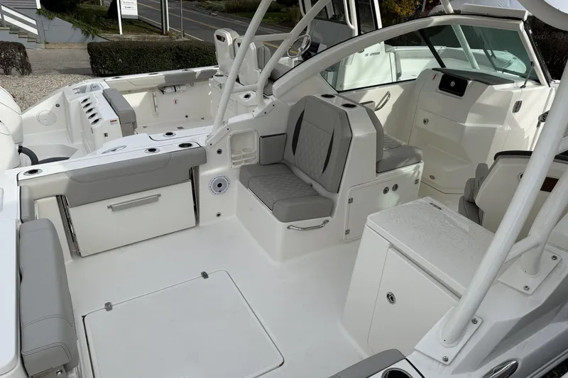 Slide: The Image of 2026 Pursuit DC 266 Dual Console boat interior with seating and storage compartments. - 2