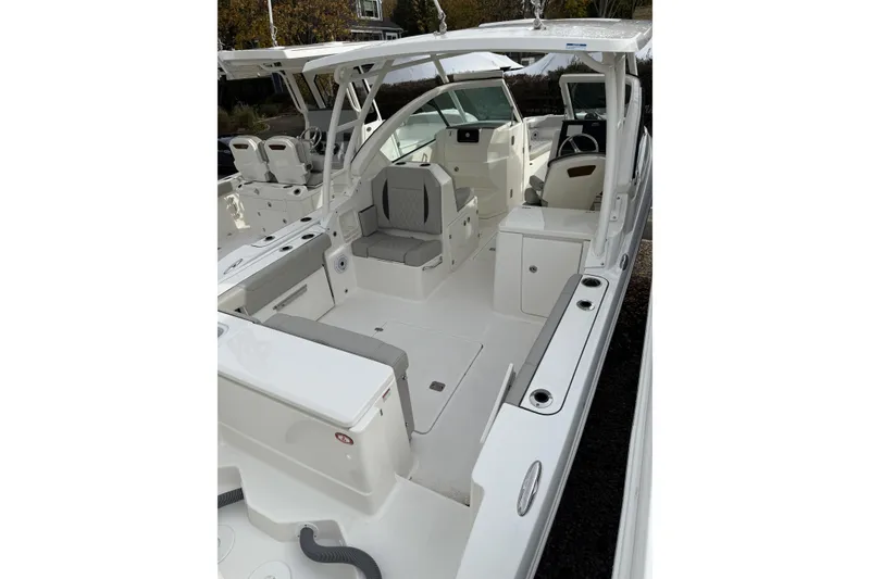 Slide: The Image of 2026 Pursuit DC 266 Dual Console boat interior with seating and helm, showcasing modern design. - 5
