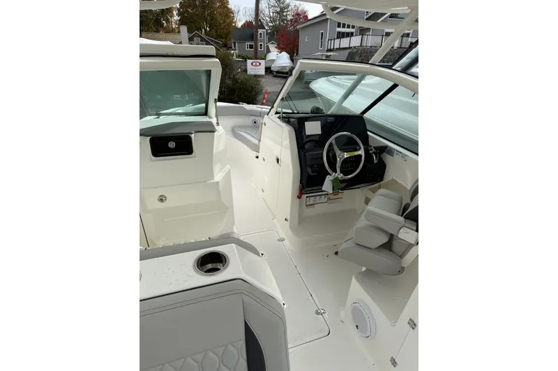 Slide: The Image of 2026 Pursuit DC 266 Dual Console boat interior with steering wheel and seating. - 6