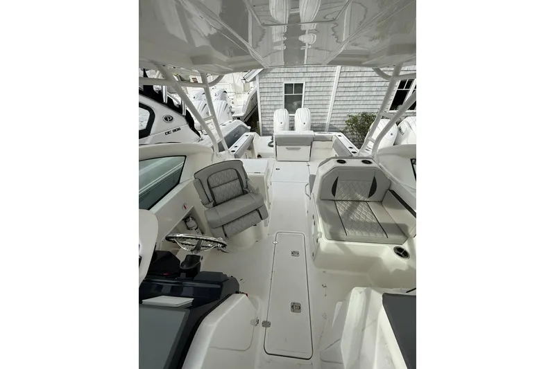 Slide: The Image of 2026 Pursuit DC 266 Dual Console boat interior with seating and helm. - 8