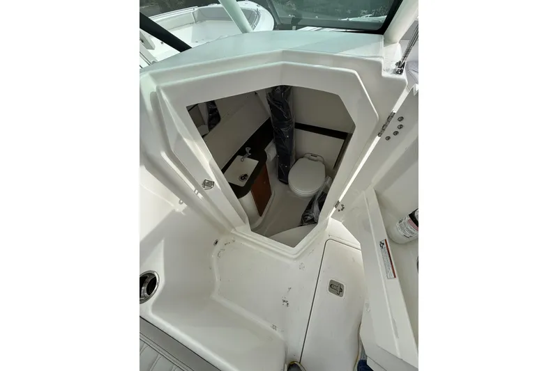 Slide: The Image of 2026 Pursuit DC 266 Dual Console boat interior with compact bathroom. - 9