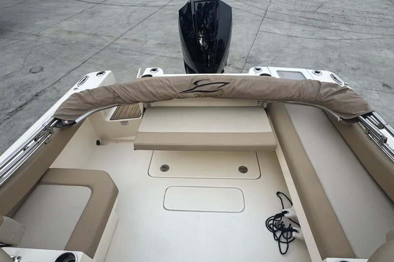 Slide: The Image of 2024 Scout 215 Dorado boat interior with beige seating and covered equipment. - 7