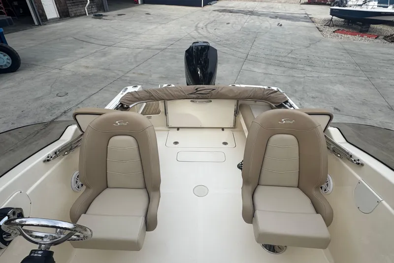 Slide: The Image of 2024 Scout 215 Dorado boat interior with beige seating and steering wheel. - 8