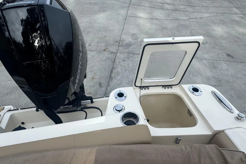 Slide: The Image of 2024 Scout 215 Dorado boat with Mercury engine and open storage compartment. - 9