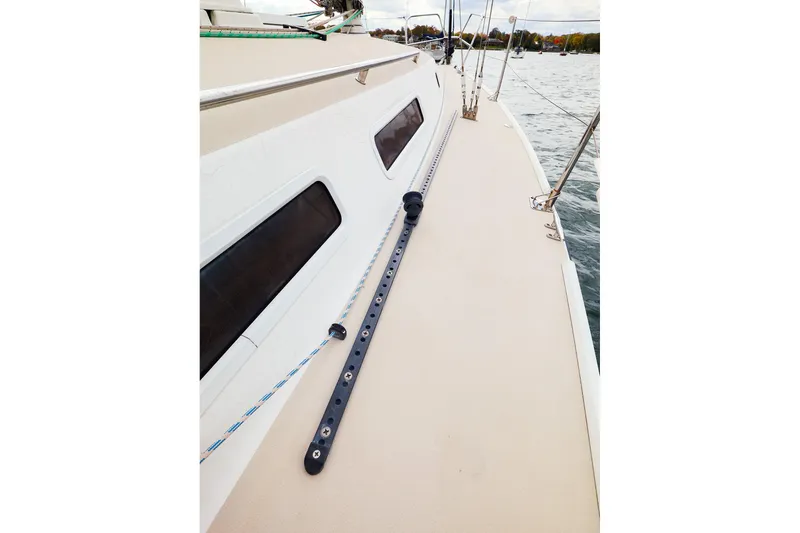 Slide: The Image of 1999 J Boats J/32 sailboat deck with rigging and windows, on calm water. - 10