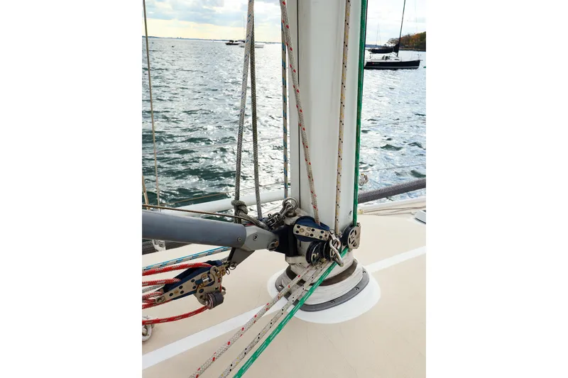 Slide: The Image of 1999 J Boats J/32 sailboat rigging detail with ropes and pulleys on deck. - 11