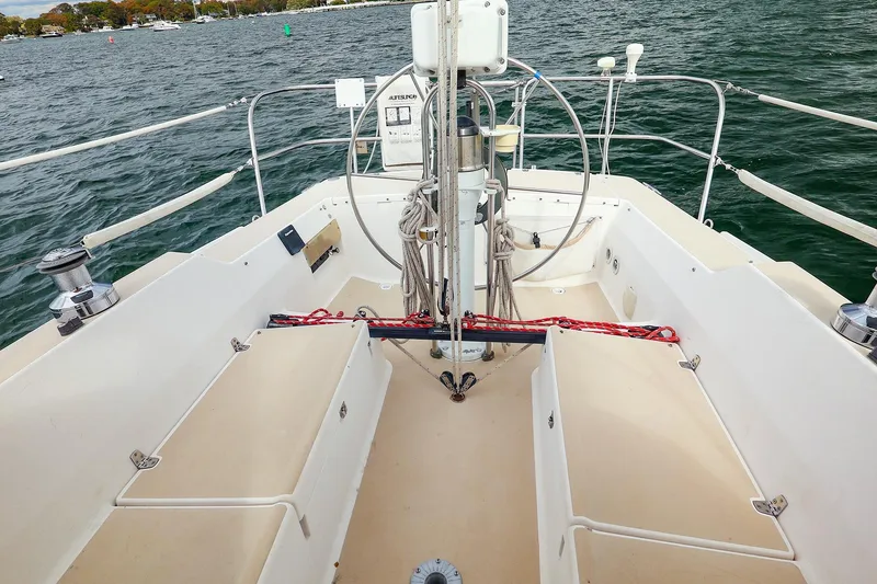 Slide: The Image of 1999 J Boats J/32 sailboat cockpit with steering wheel and rigging on open water. - 16