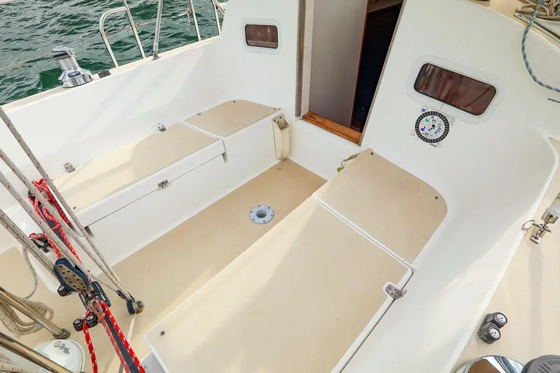 Slide: The Image of 1999 J Boats J/32 sailboat cockpit with seating and nautical equipment. - 17