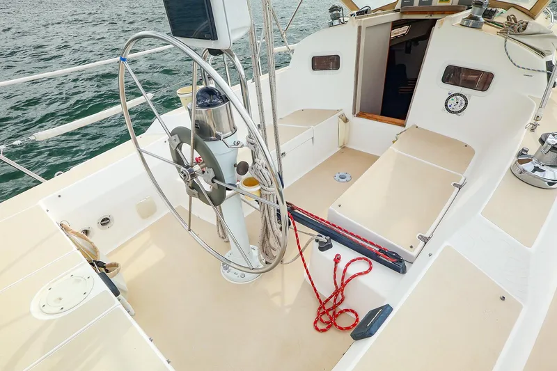 Slide: The Image of 1999 J Boats J/32 sailboat cockpit with steering wheel and nautical equipment. - 18