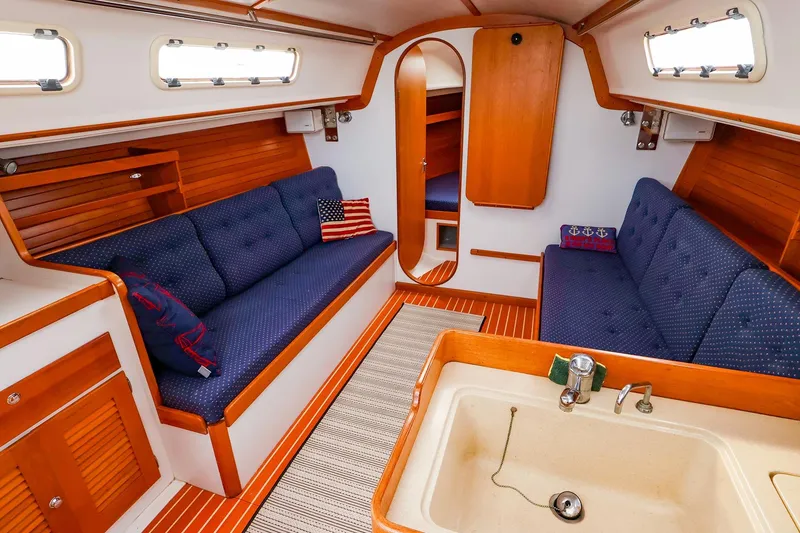 Slide: The Image of Interior of a 1999 J Boats J/32 sailboat with cozy seating and wooden finishes. - 19