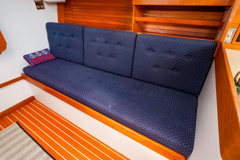 Slide: The Image of Interior of 1999 J Boats J/32 with blue cushioned seating and nautical decor. - 26