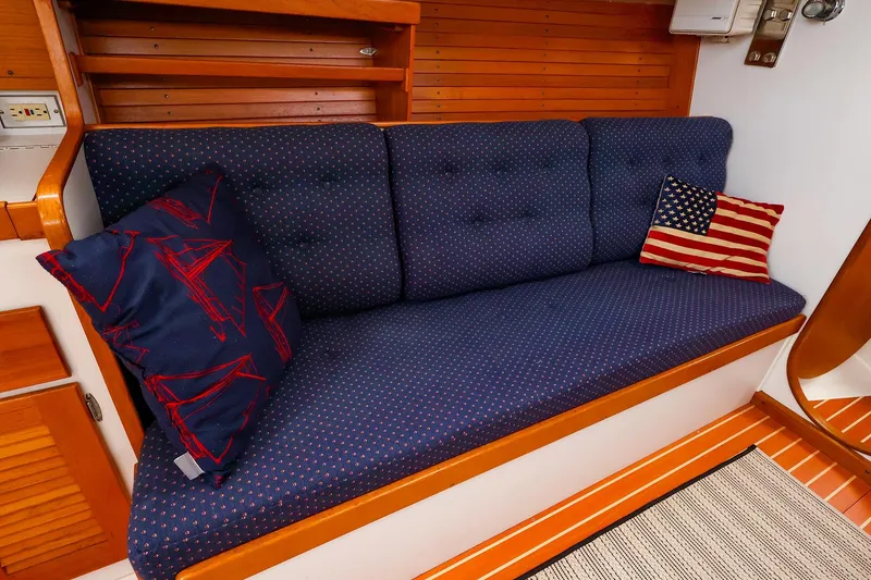 Slide: The Image of Cozy interior of 1999 J Boats J/32 with blue cushions and decorative pillows. - 27