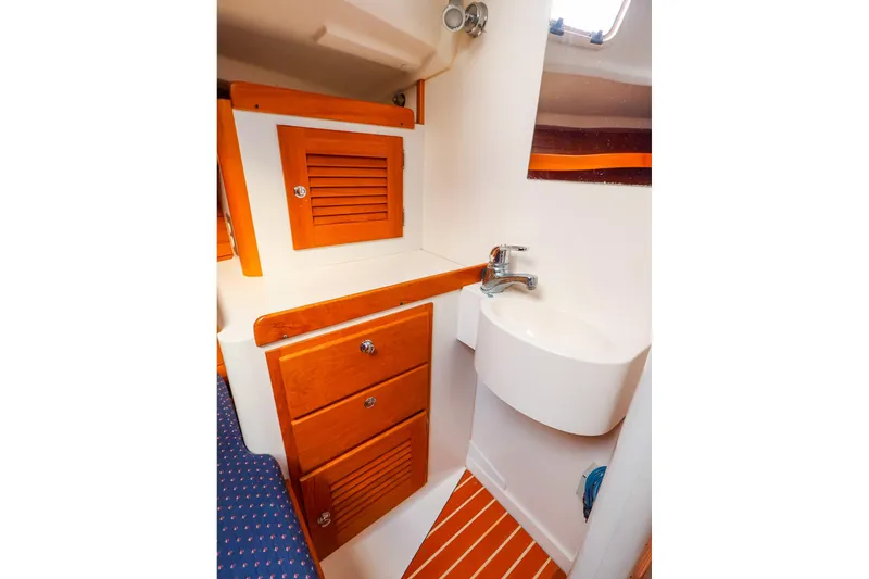 Slide: The Image of 1999 J Boats J/32 interior with wooden cabinets and compact sink. - 29