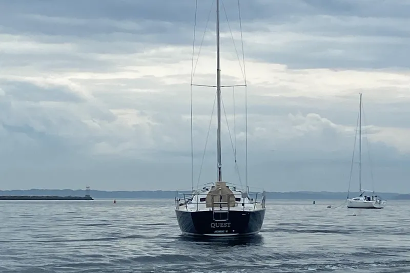 Slide: The Image of Sailboat J/32 from 1999 on calm waters under cloudy skies. - 3