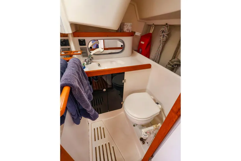 Slide: The Image of 1999 J Boats J/32 yacht bathroom with sink, toilet, and storage. - 30