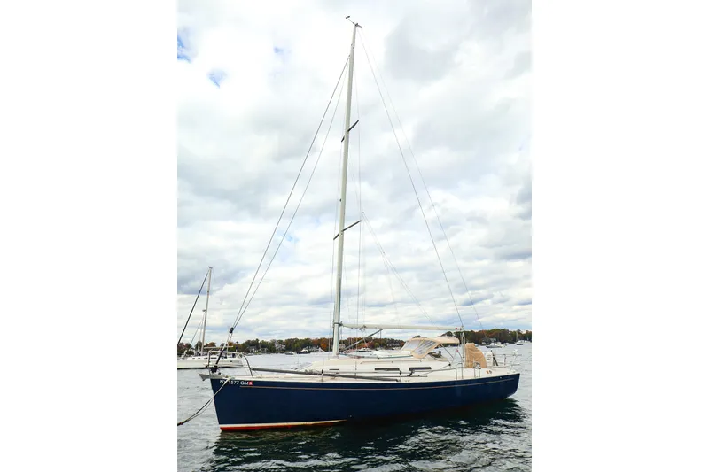 Slide: The Image of 1999 J Boats J/32 sailboat on water under cloudy sky. - 6