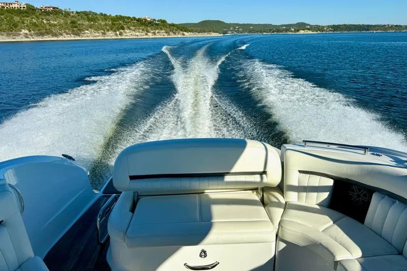 Slide: The Image of Luxury Cobalt 323 boat cruising on a serene lake, leaving a wake trail. - 11
