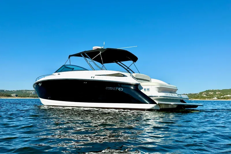 Slide: The Image of 2007 Cobalt 323 boat on calm water under clear blue sky. - 2