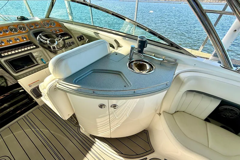 Slide: The Image of Interior of a 2007 Cobalt 323 boat with steering wheel and sink, overlooking water. - 20