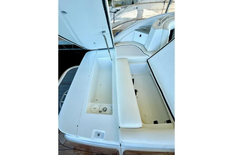 Slide: The Image of 2007 Cobalt 323 boat interior with open storage compartment and white seating. - 22