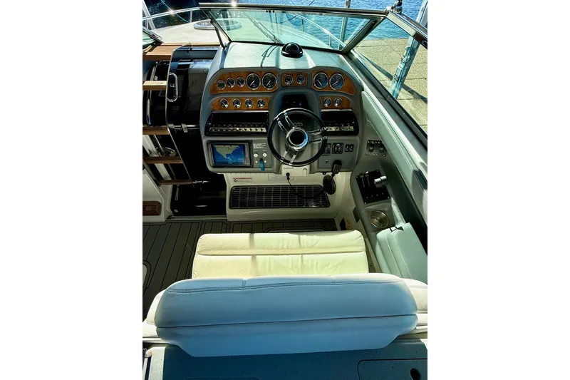 Slide: The Image of Cockpit of 2007 Cobalt 323 boat with steering wheel and navigation controls. - 24