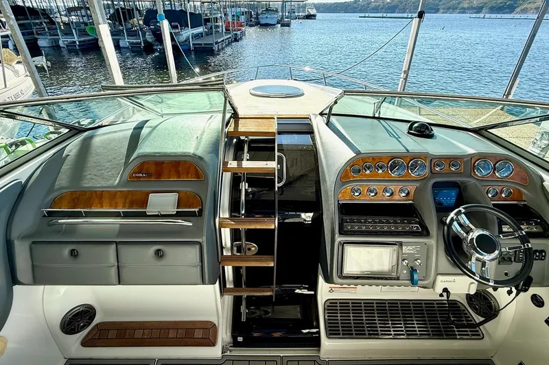 Slide: The Image of 2007 Cobalt 323 boat dashboard with steering wheel, gauges, and navigation equipment at marina. - 26