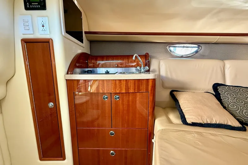 Slide: The Image of Luxurious interior of a 2007 Cobalt 323 boat with wood cabinetry and plush seating. - 30