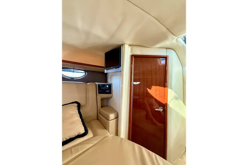 Slide: The Image of Interior of 2007 Cobalt 323 boat with plush seating and wooden door. - 33