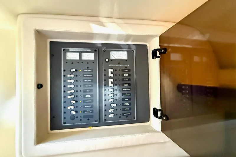 Slide: The Image of Electrical panel inside a 2007 Cobalt 323 boat, featuring various switches and meters. - 34