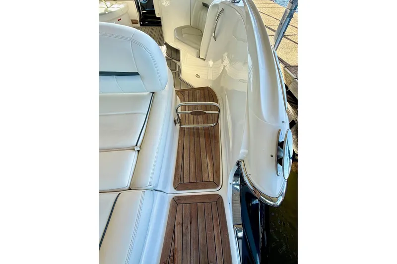 Slide: The Image of 2007 Cobalt 323 boat interior with white seating and wooden flooring. - 36