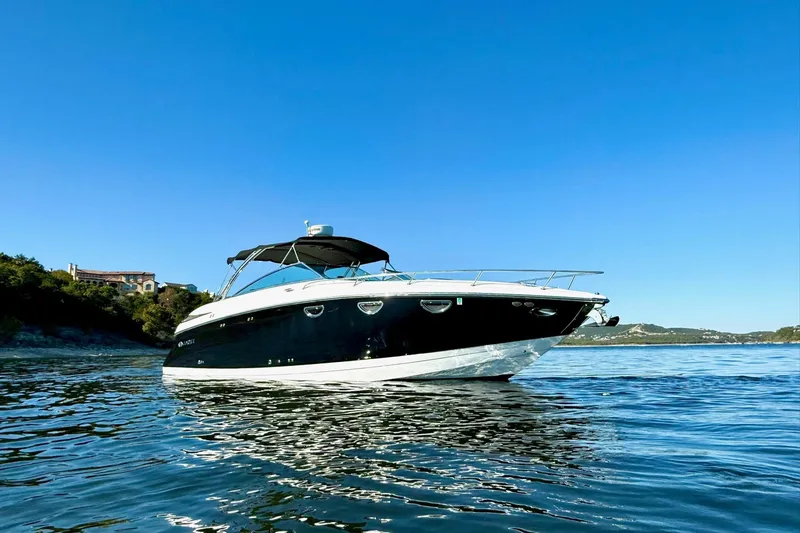 Slide: The Image of 2007 Cobalt 323 boat on calm water under clear blue sky. - 4
