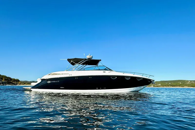 Slide: The Image of 2007 Cobalt 323 boat on calm water under clear blue sky. - 5
