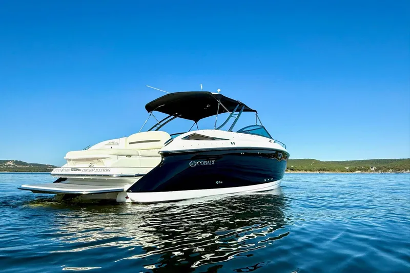 Slide: The Image of 2007 Cobalt 323 boat on calm water under clear blue sky. - 6