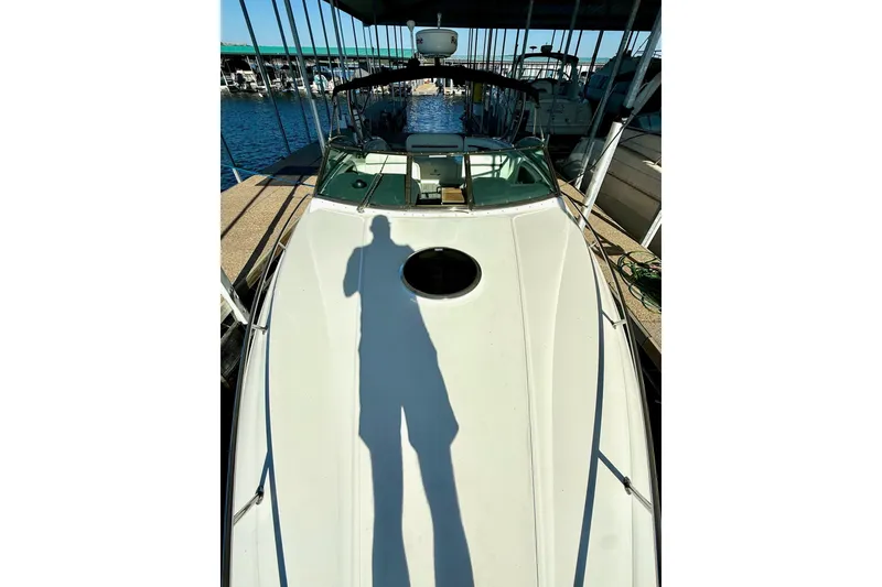 Slide: The Image of 2007 Cobalt 323 boat docked, shadow on deck, marina background. - 8