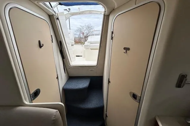 Slide: The Image of Interior view of 2003 Bayliner 285 boat with steps leading to deck. - 16