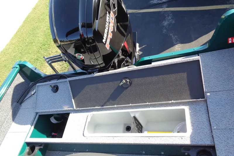 Slide: The Image of 2026 Lund 1800 Explorer Sport boat with Mercury Pro outboard motor, featuring storage compartments. - 13